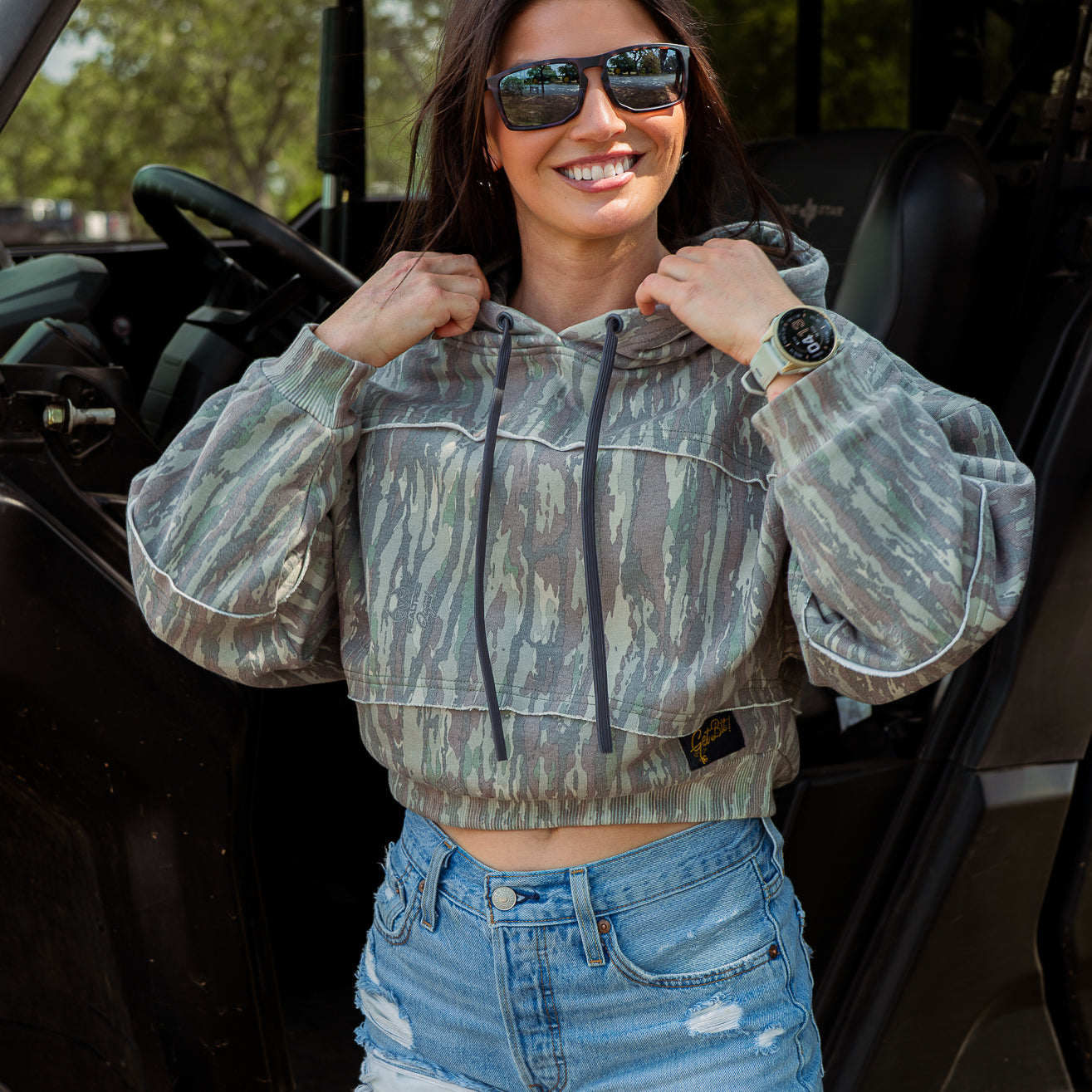 Woman wearing crop camo hoodie