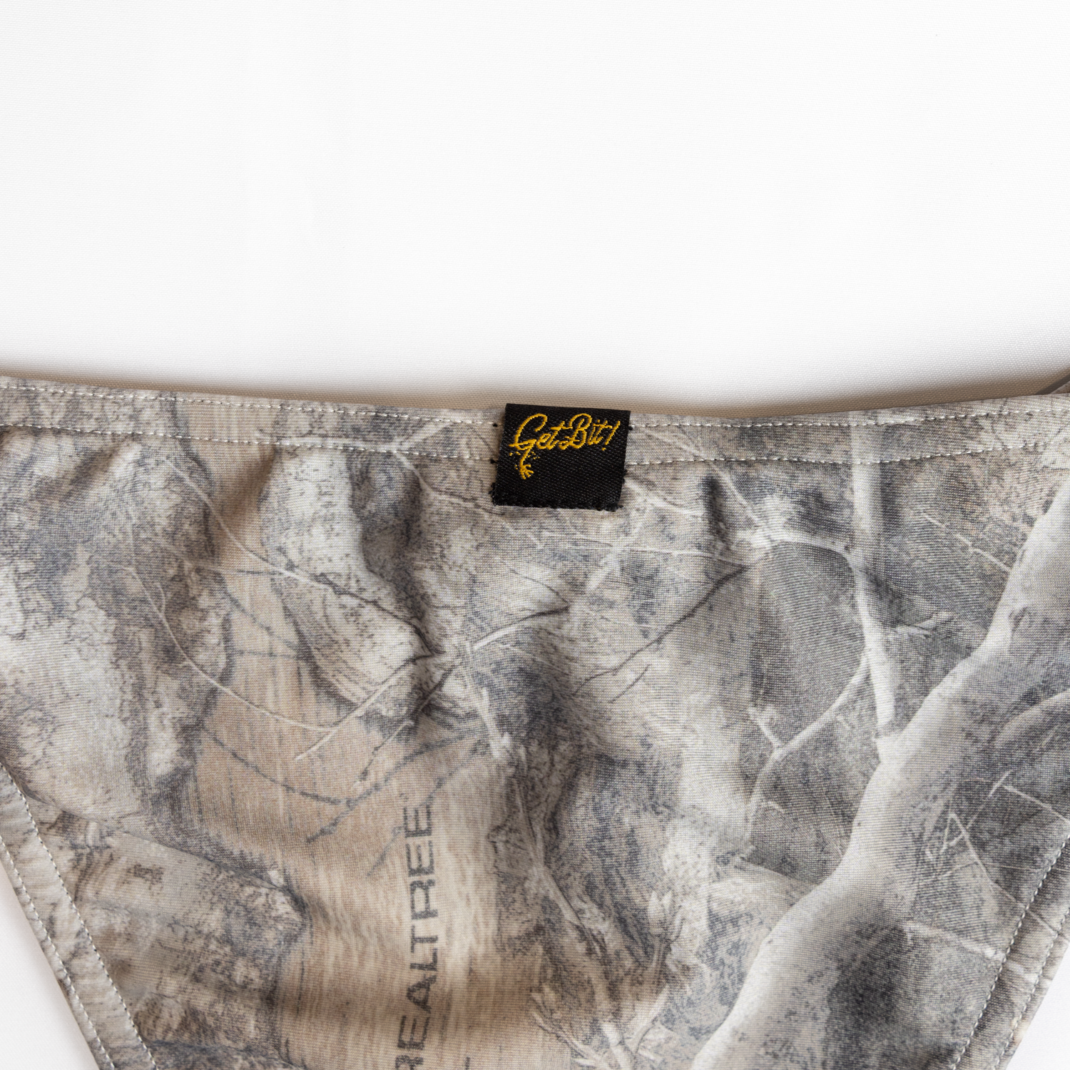 closeup of "Get Bit!" logo on camo bikini