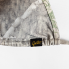 Camouflage-patterned Bikini with a black label on a white background