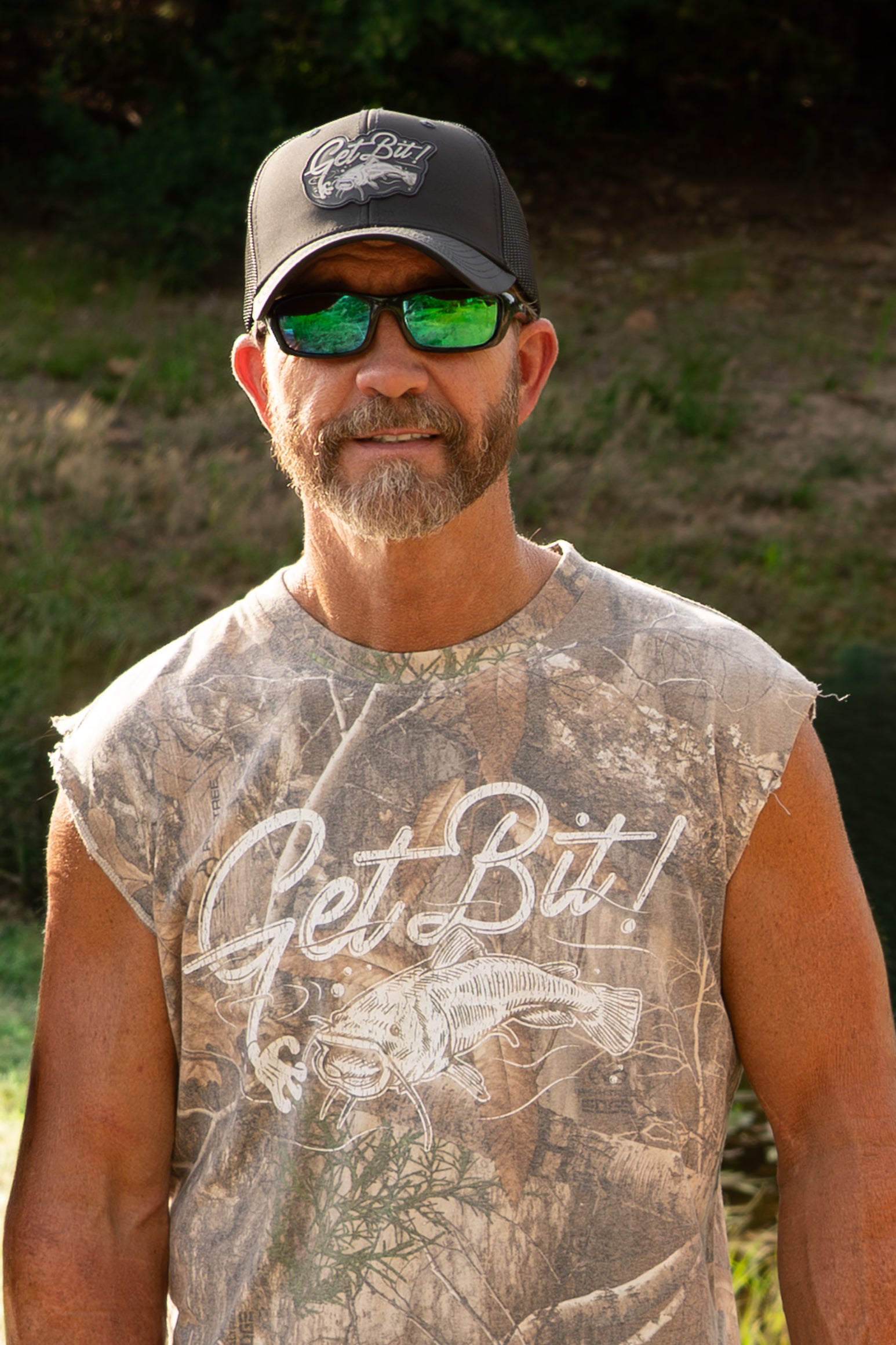 Man wearing camo shirt and black "Get Bit!" hat