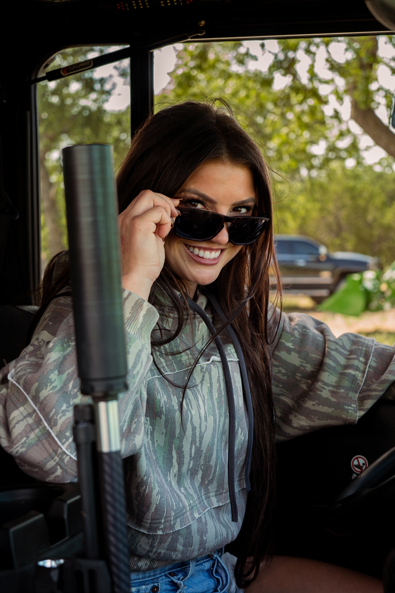 Woman in vehicle wearing crop camo hoodie