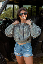 Woman wearing crop camo hoodie