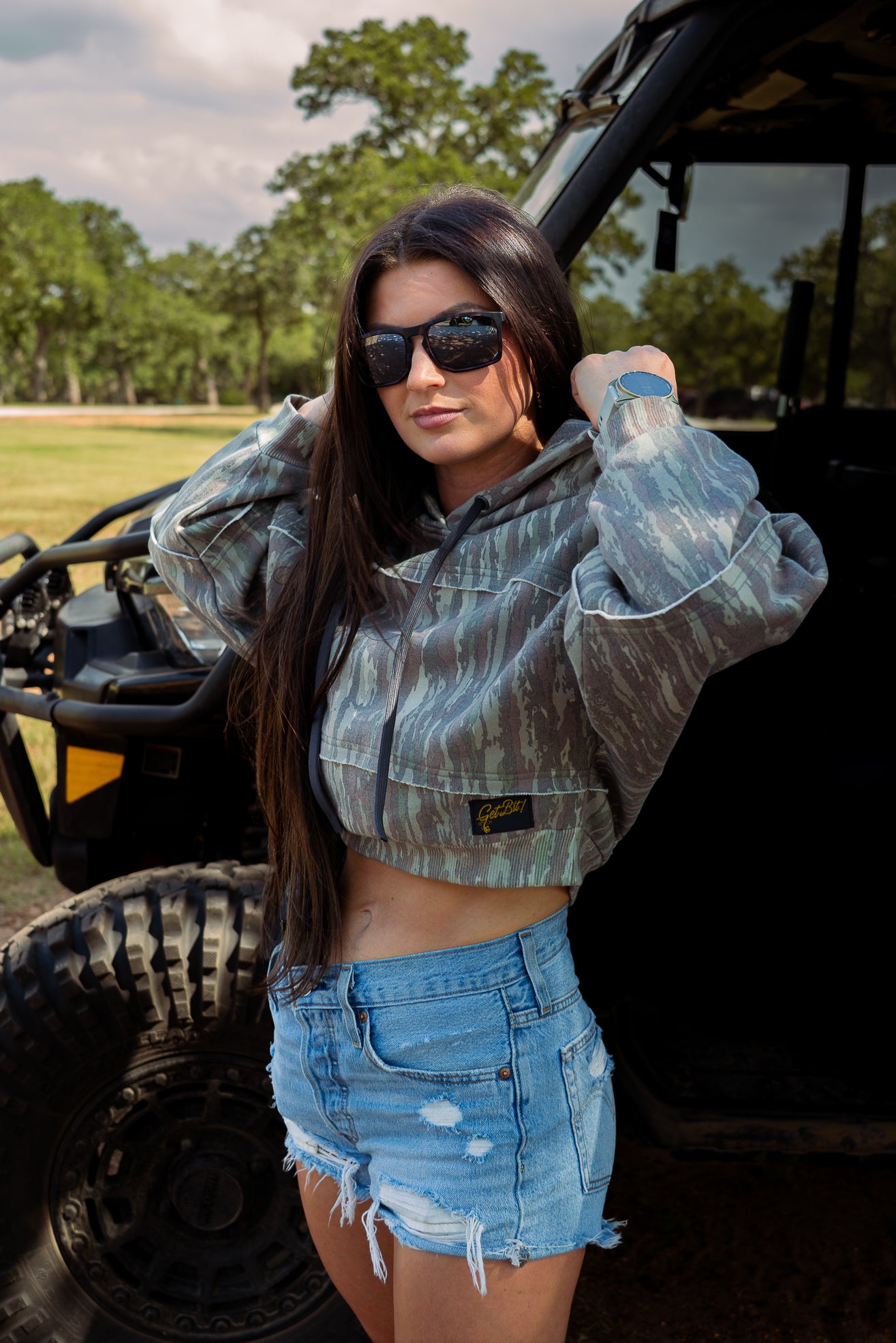 Woman wearing crop camo hoodie