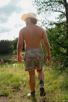 rear view of man in camo swim trunks
